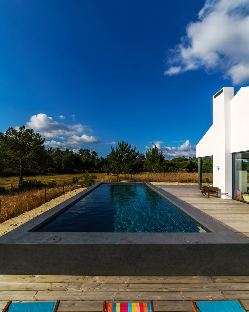 Modern house with garden swimming pool and wooden deck